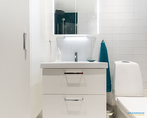 Ljust badrum med mörkblå mosaik