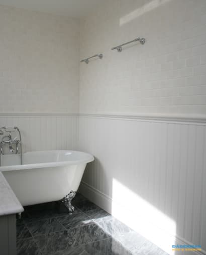 Badrum med marmorgolv och dubbelhandfat